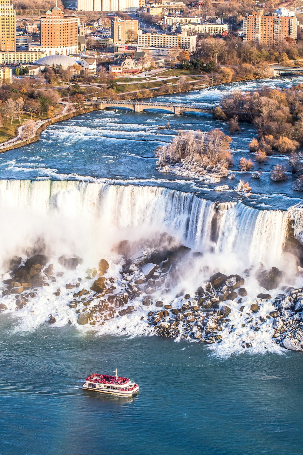 people surfing on water falls during daytime