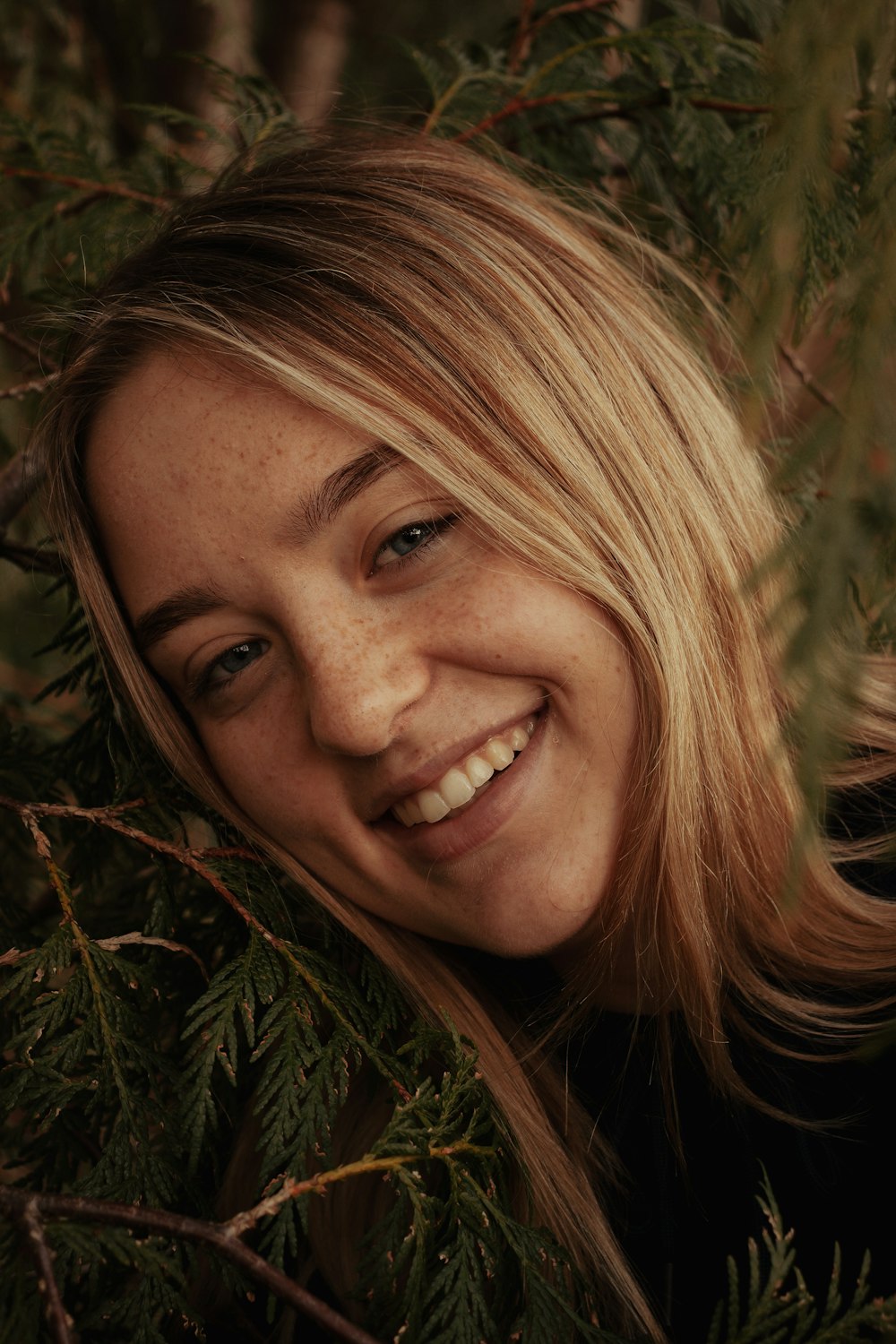 woman smiling in front of green grass