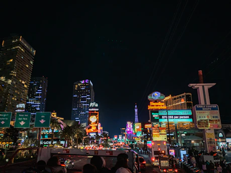 Vibrant city nightlife with neon lights and people enjoying an evening out.