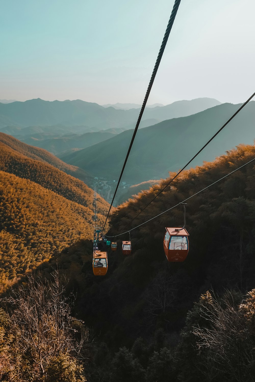 cable cars over the mountains during daytime