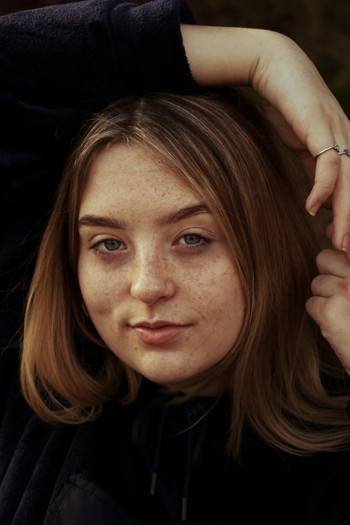 Woman with brown hair holding and showing the length and texture of her hair