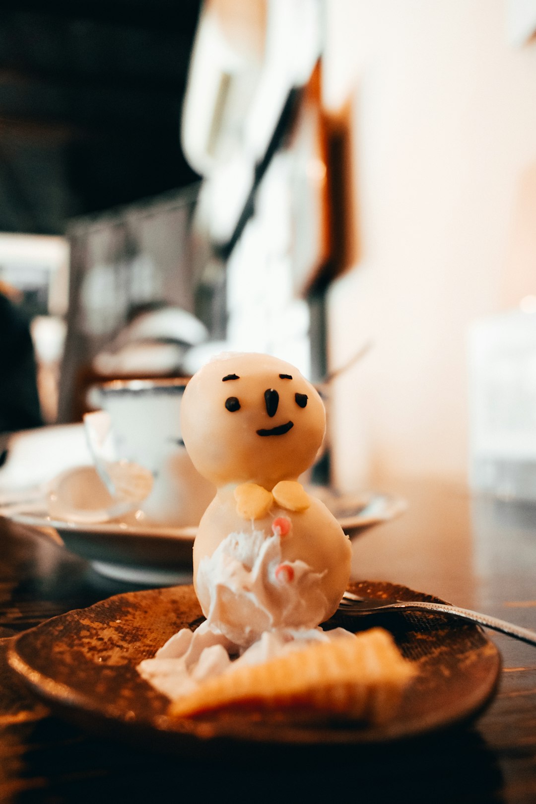 white snowman ceramic figurine on brown wooden table