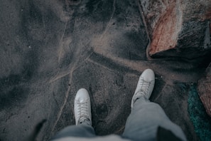 A pair of lightweight wind-ready sneakers on a rocky trail.
