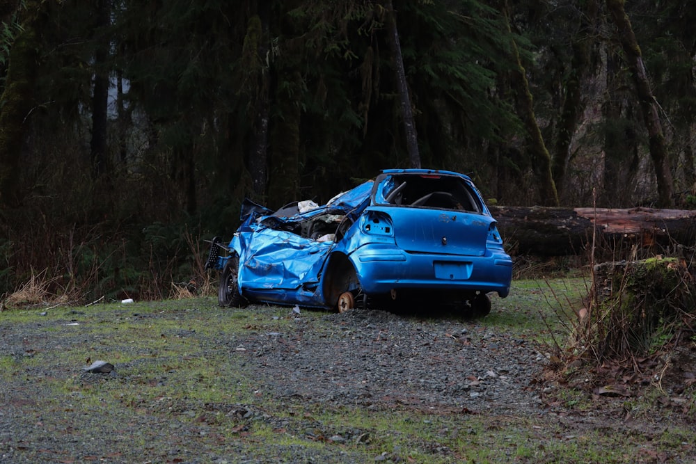 blue sedan parked on green grass field during daytime