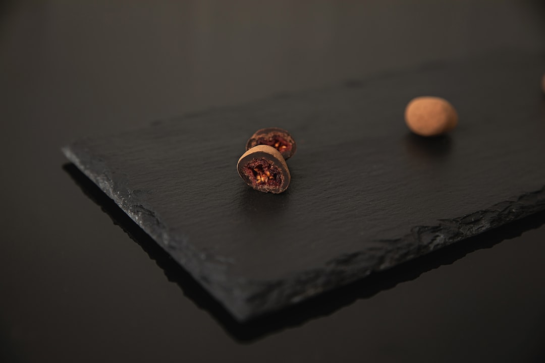 brown and white stone fragment on black wooden table