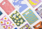Close-up of vibrant notebooks and cases adorned with animated series characters, stacked invitingly.