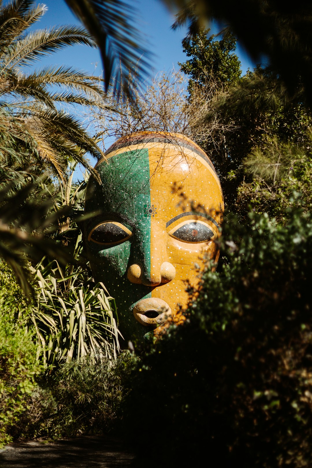 green and brown tree with face and face mask