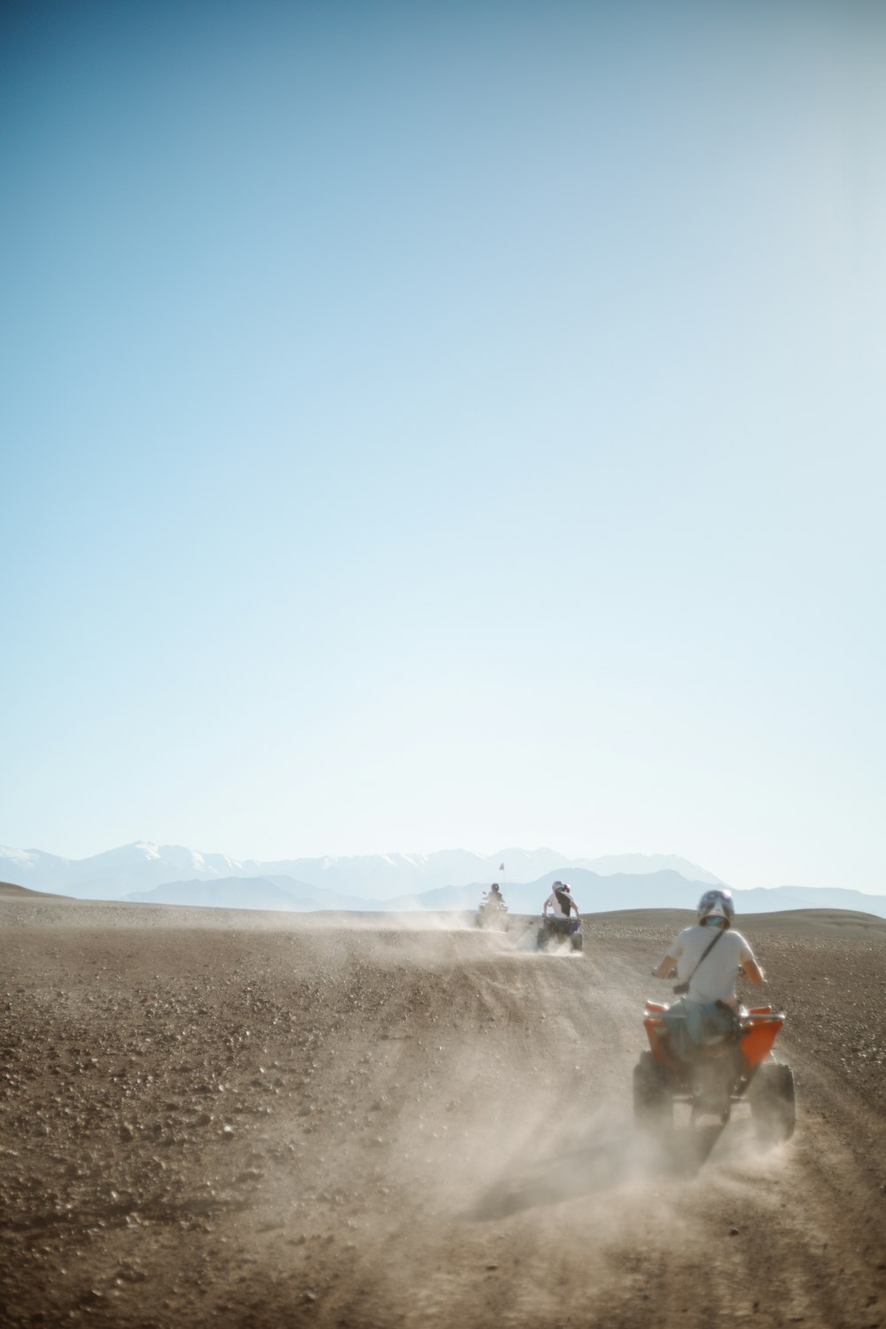 people riding camel on desert during daytime