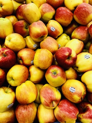 Stacked cartons of freshly packed apples ready for export, with the Altapples logo visible.