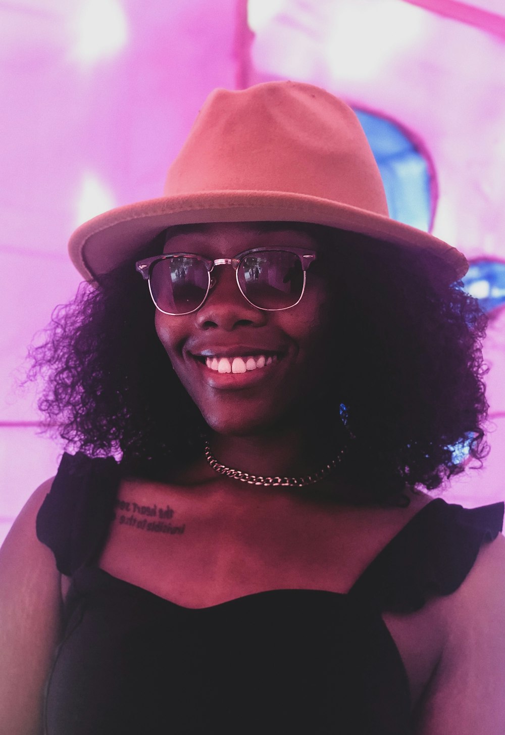 woman in black tank top wearing pink hat