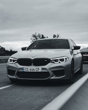 grayscale photo of bmw m 3 on road