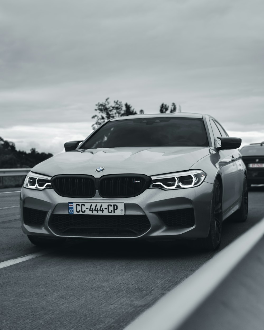 grayscale photo of bmw m 3 on road