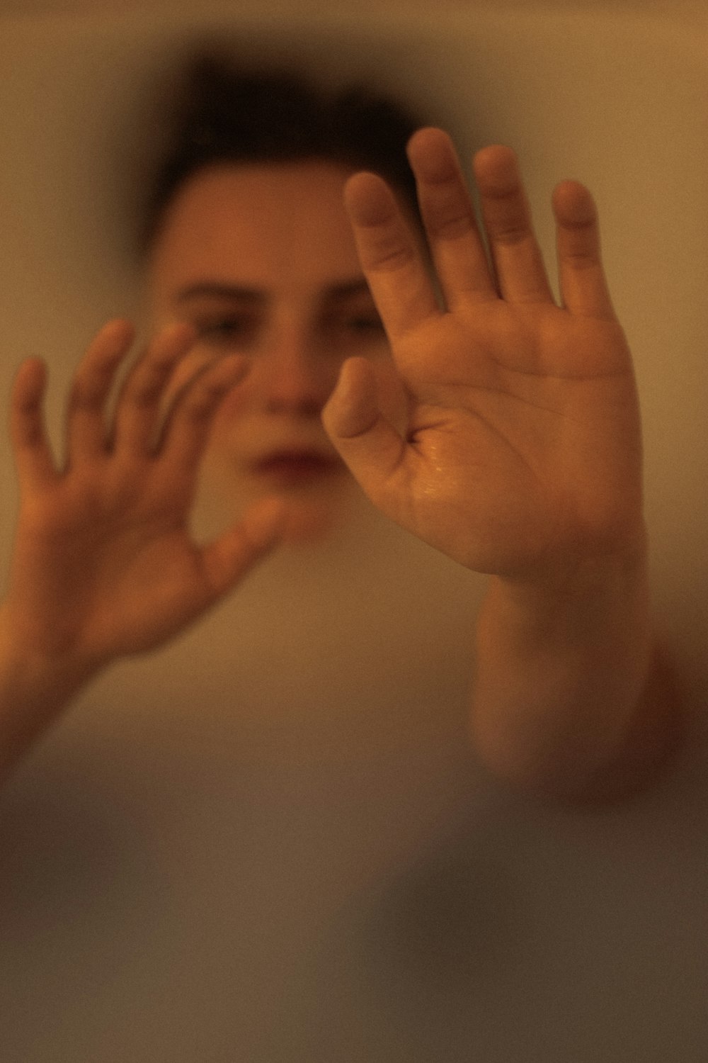 topless child covering face with hand