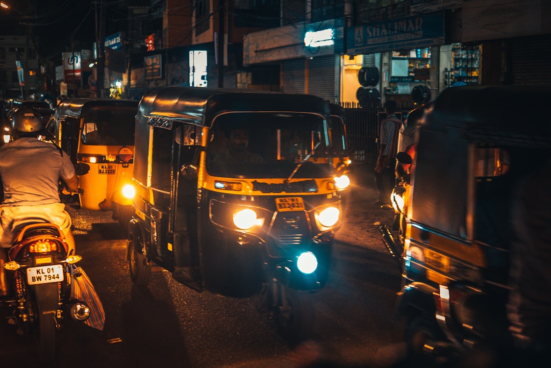 black and yellow auto rickshaw on road during nighttime