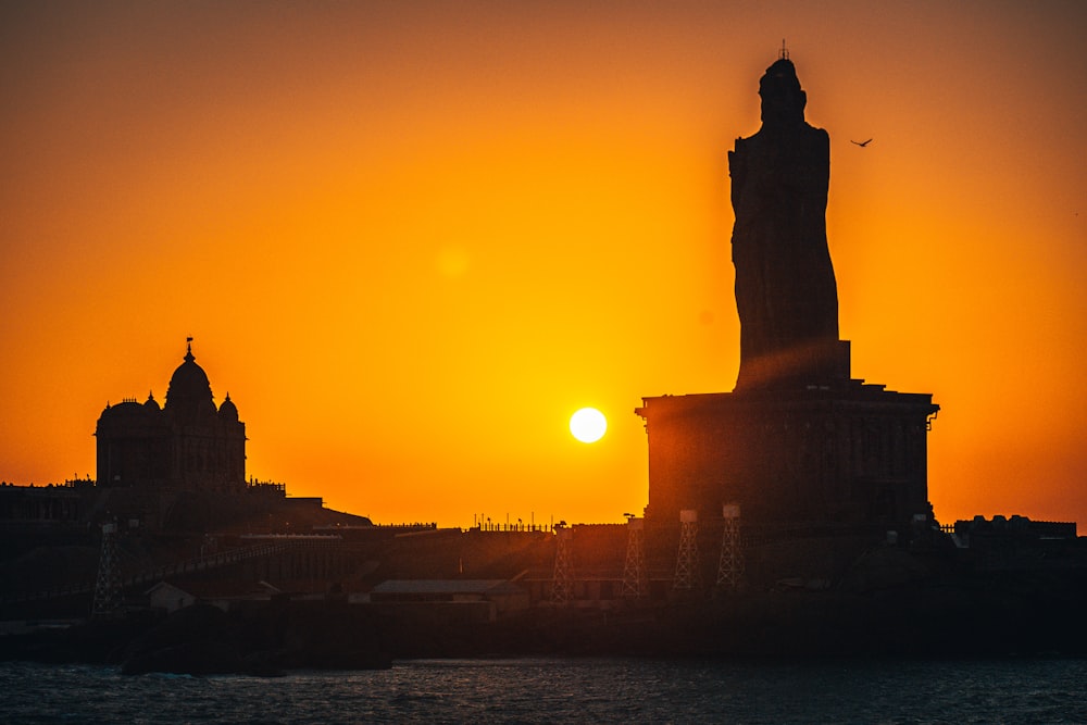 silhouette of statue of liberty during sunset