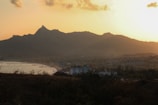 A scenic view of a coastal village at sunset.