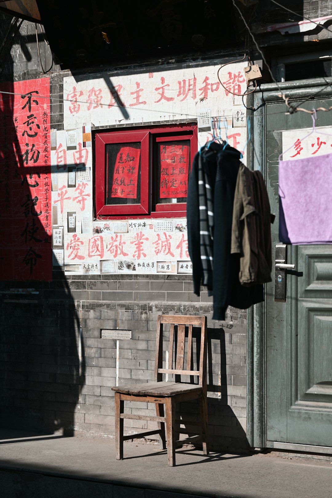 black jacket hanging on brown wooden chair