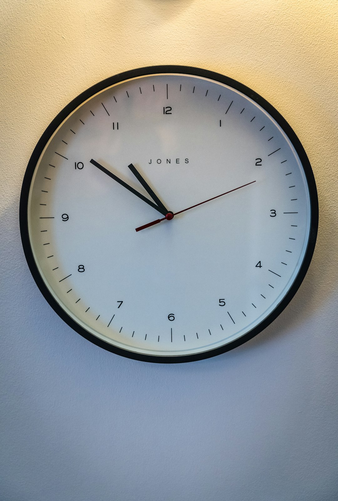 black round analog wall clock at 10 00