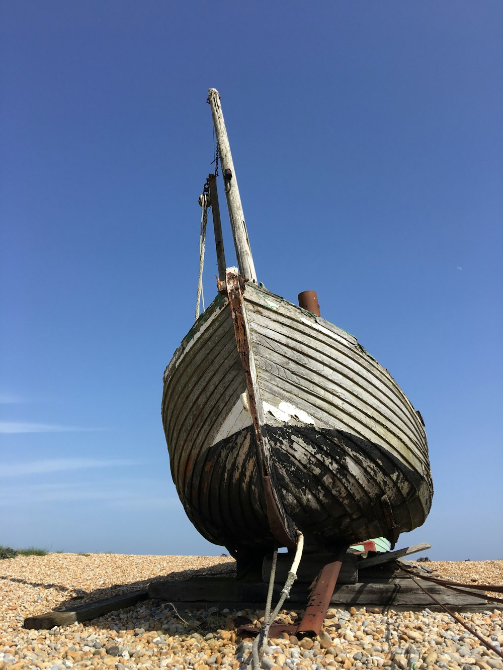 brown wooden boat on brown sand during daytime
