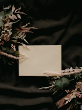 white paper on black and green floral textile