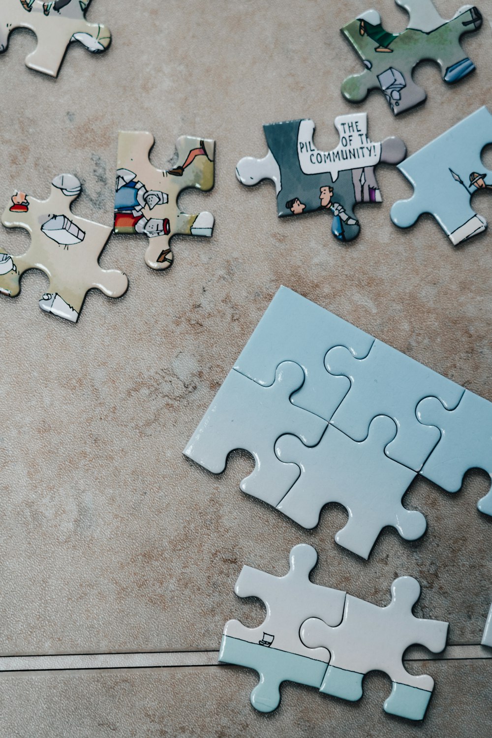 white jigsaw puzzle pieces on brown marble table