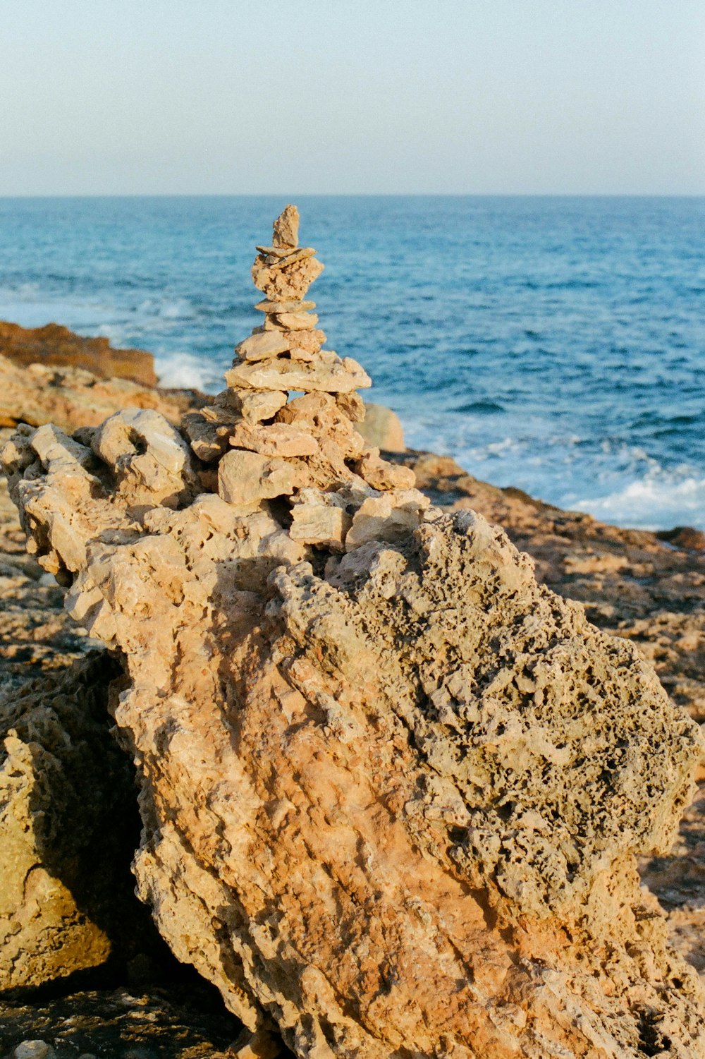 gray rock formation near body of water during daytime