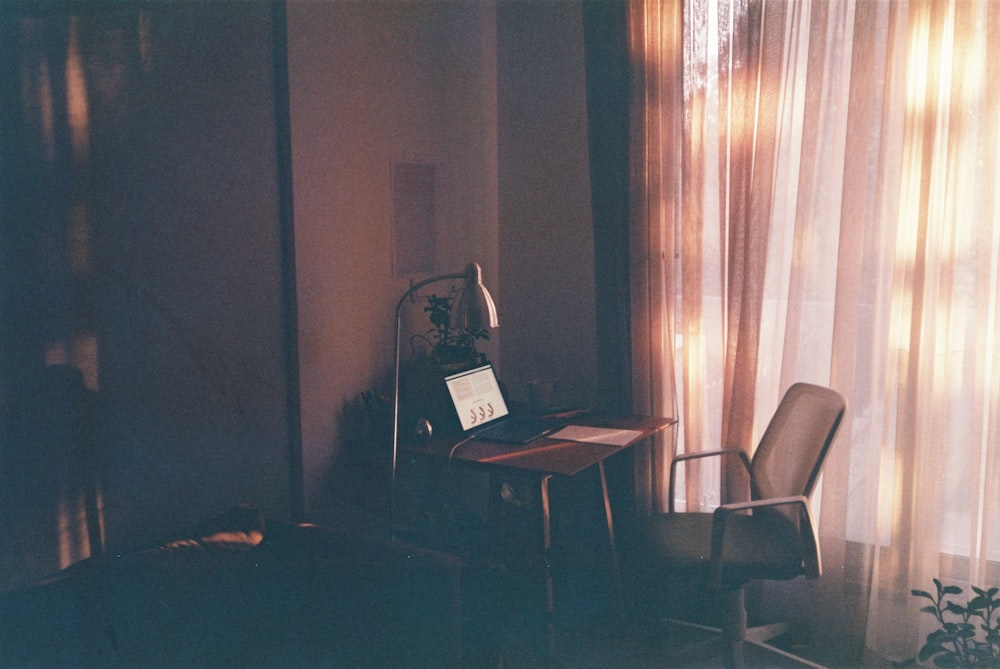 black laptop computer on brown wooden table