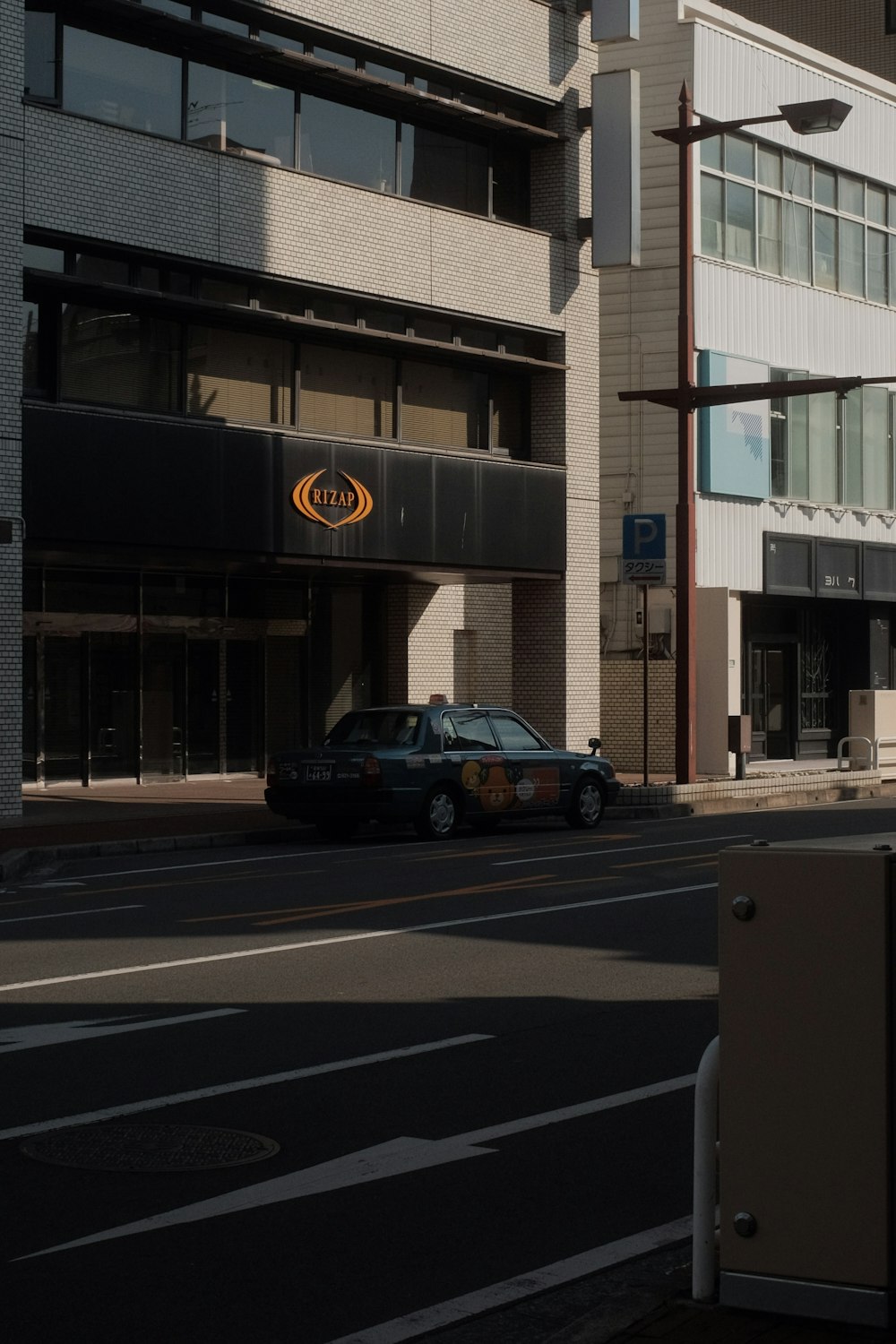 black suv parked in front of brown and white concrete building during daytime