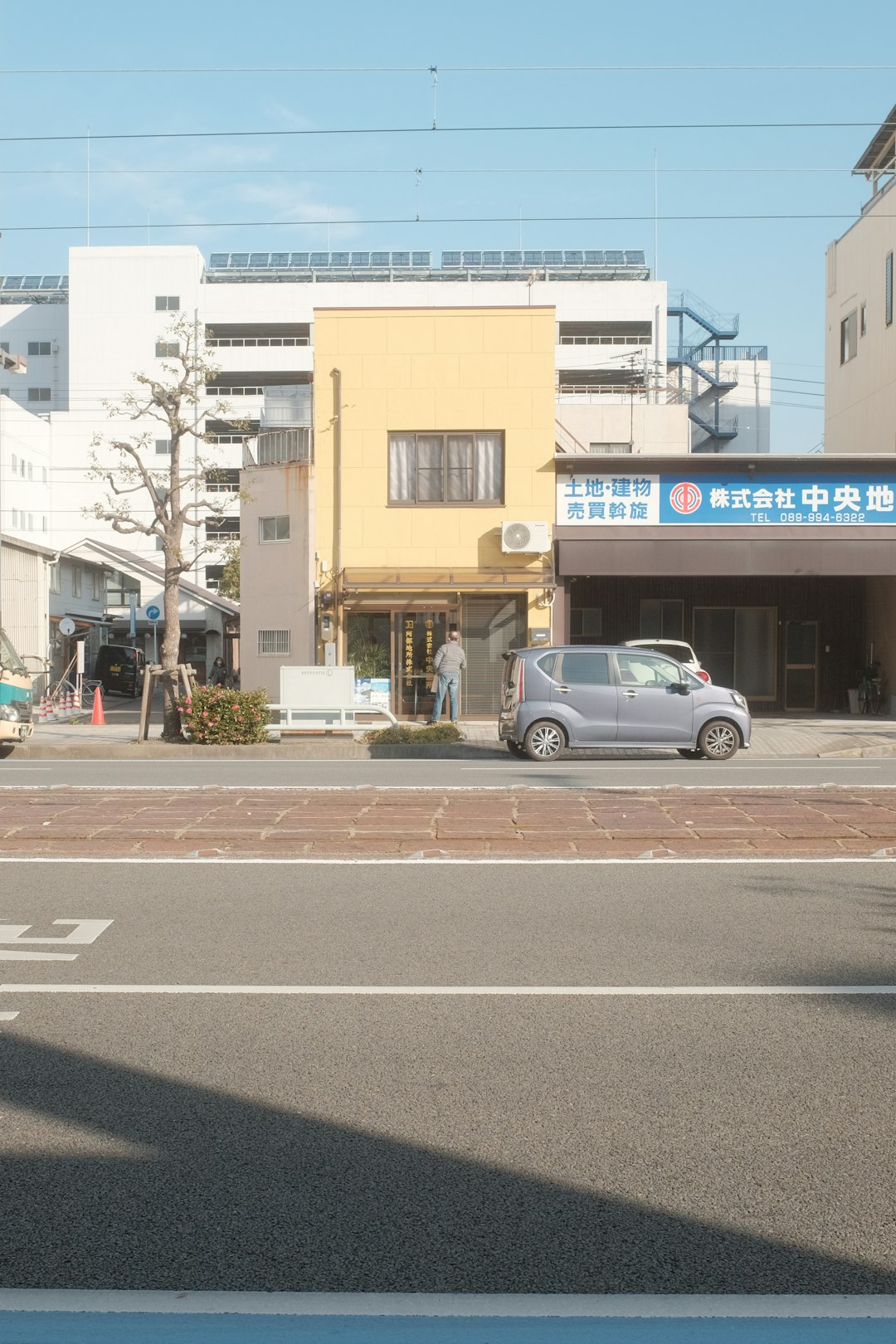 silver sedan on road near building during daytime