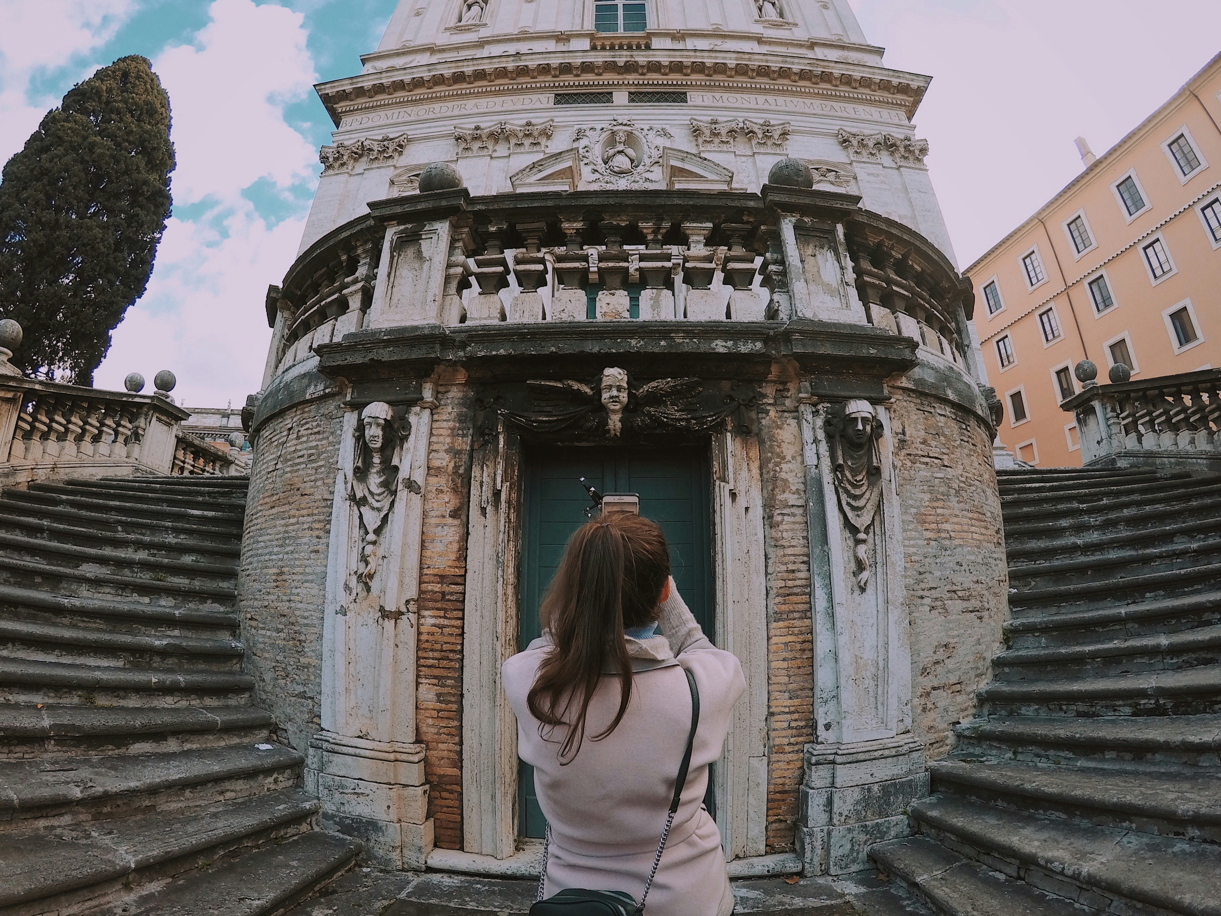 woman in white shirt standing on stairs during daytime