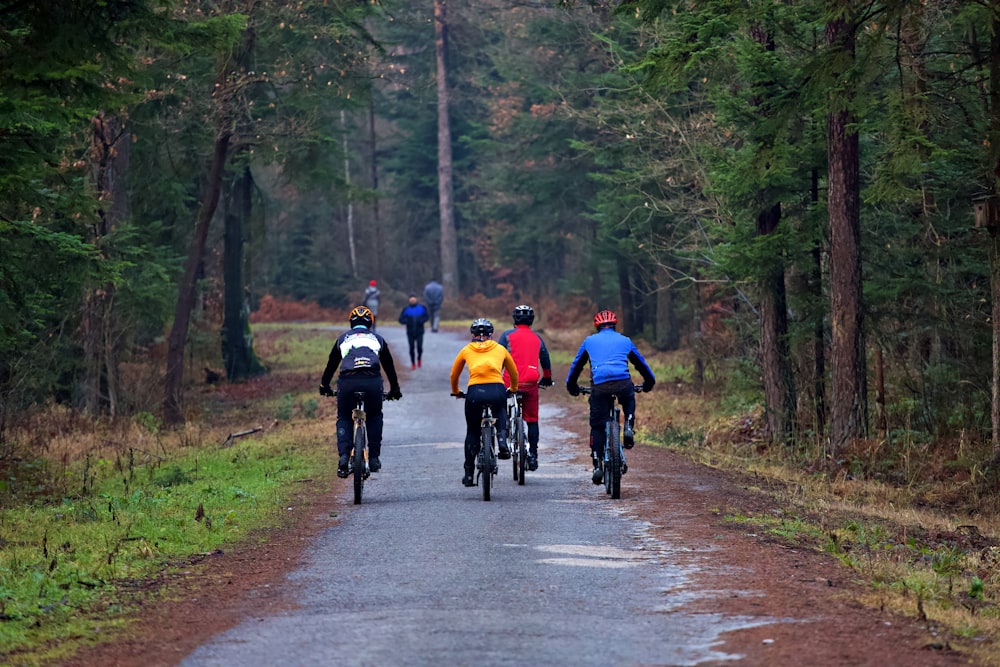 people riding bicycles on road during daytime