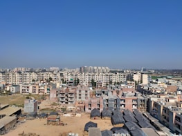 Panoramic view of completed apartment buildings in Fortaleza under a clear blue sky.