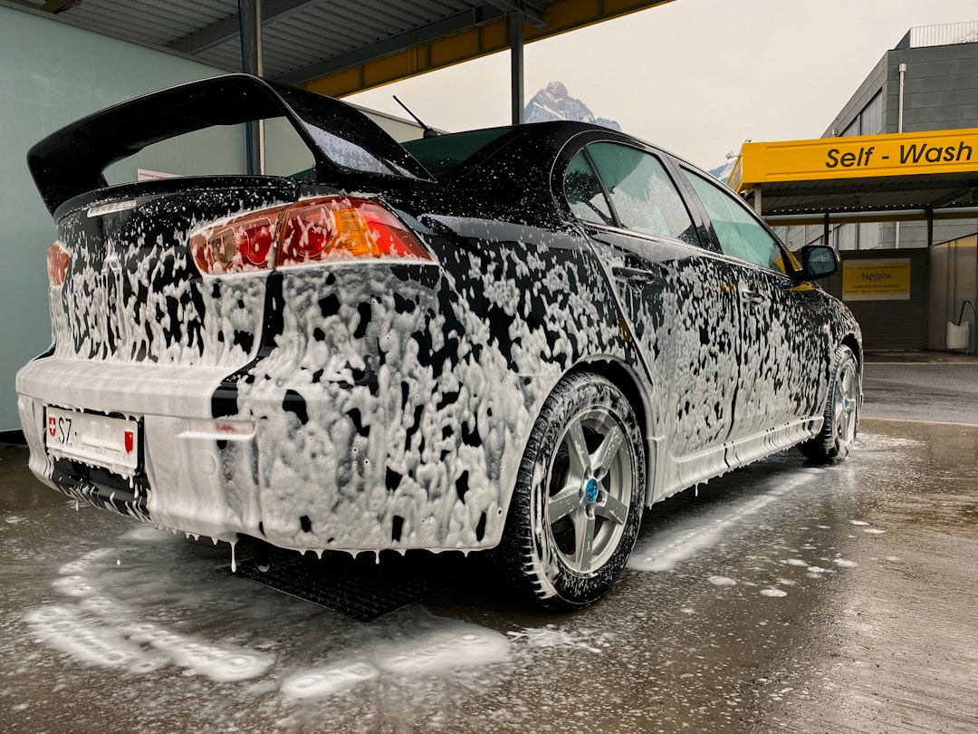 white and black car on gray concrete floor