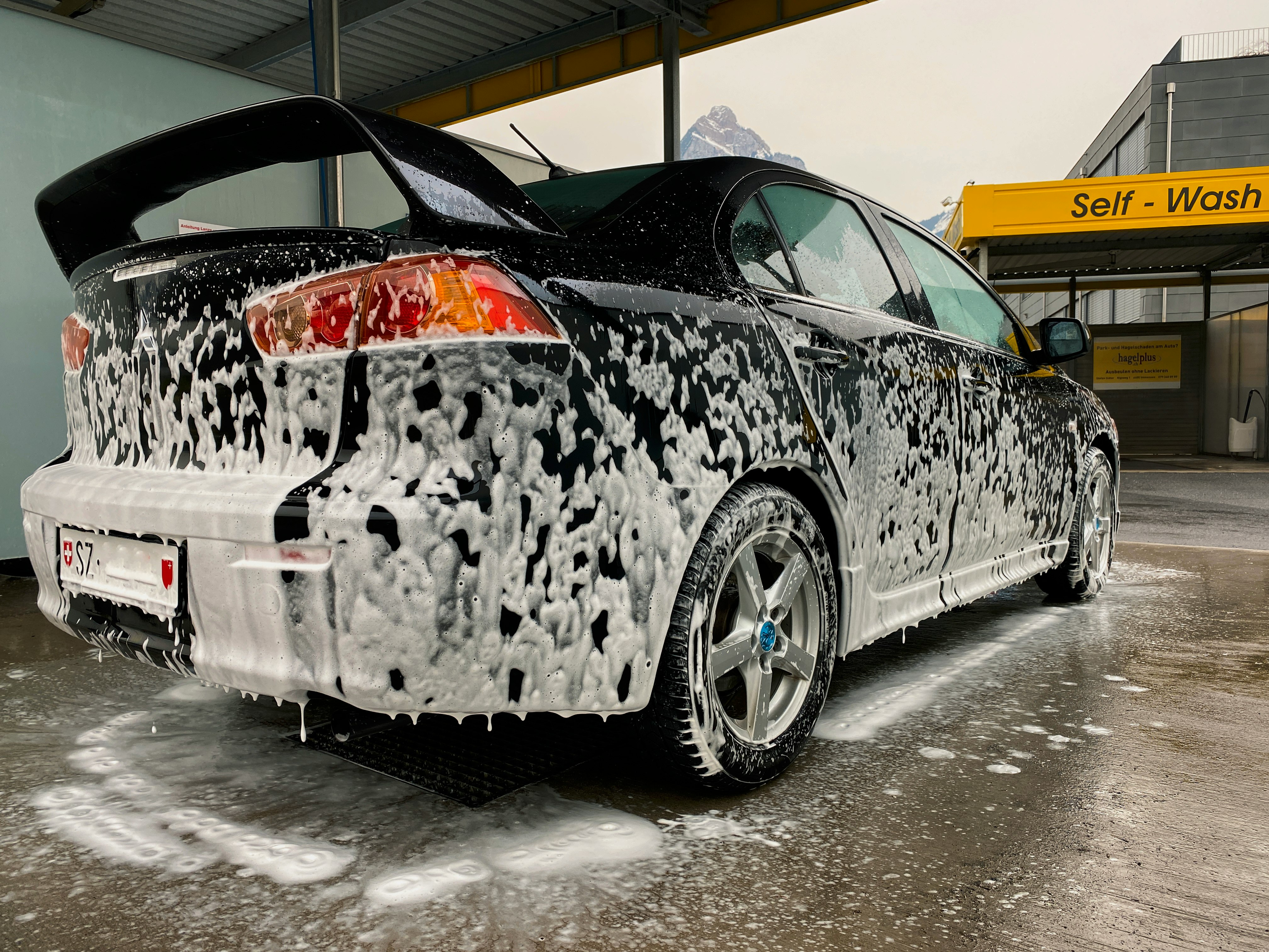 white and black car on gray concrete floor