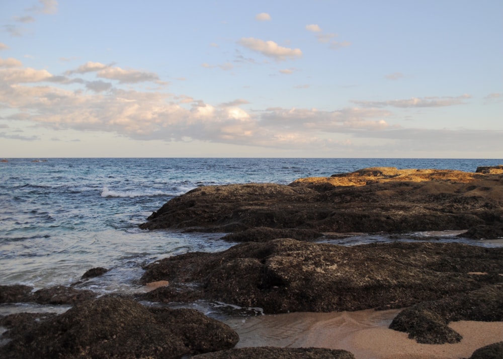 brown rock formation on sea shore during daytime