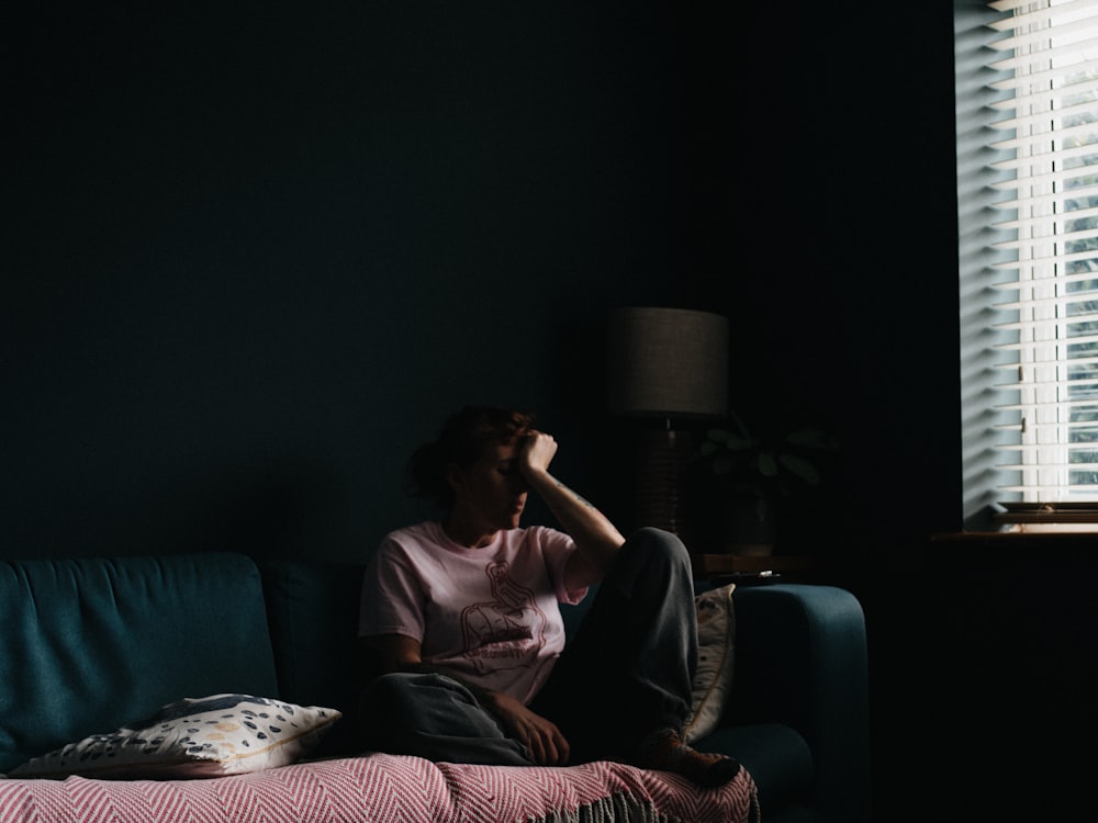 woman in purple dress sitting on couch