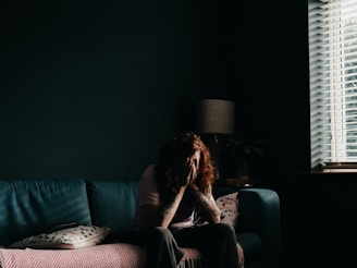 woman in black tank top sitting on black couch