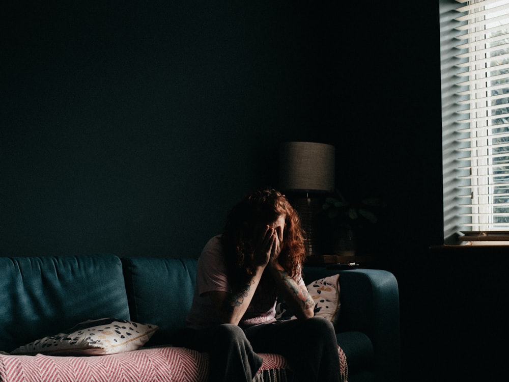 woman in black tank top sitting on black couch