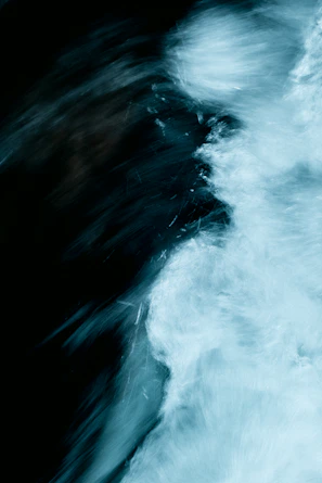 Minimalist representation of data streams converging into a dynamic, shifting pattern