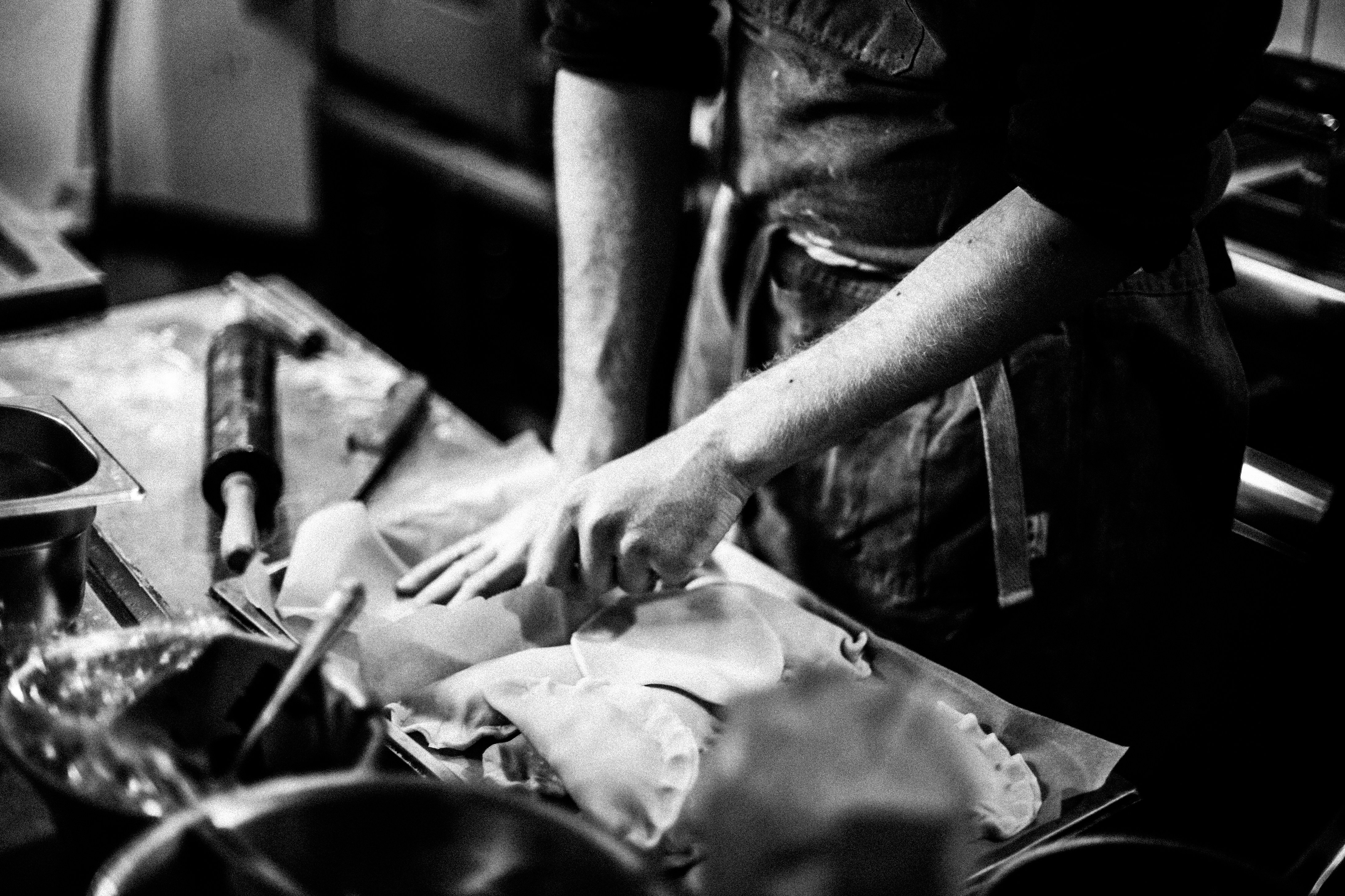 grayscale photo of man in black t-shirt holding knife