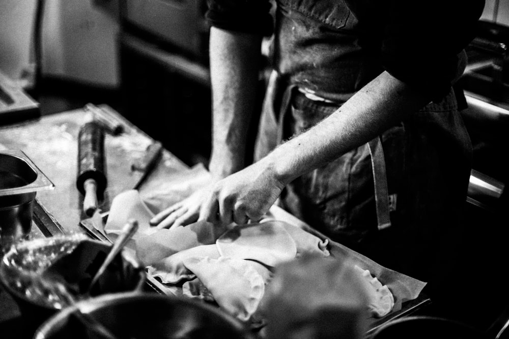 grayscale photo of man in black t-shirt holding knife