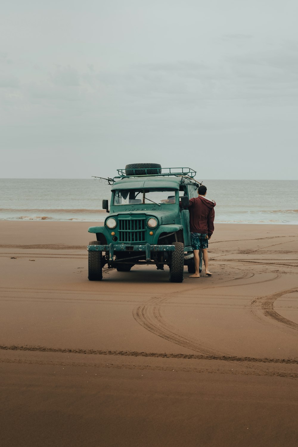 green jeep wrangler on beach during daytime