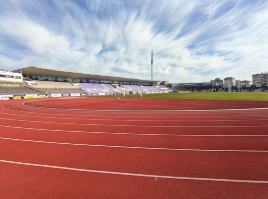 Red and white track field under blue sky during daytime — Veliko Tarnovo, Bulgaria