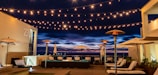 An outdoor patio lit by decorative string lights.