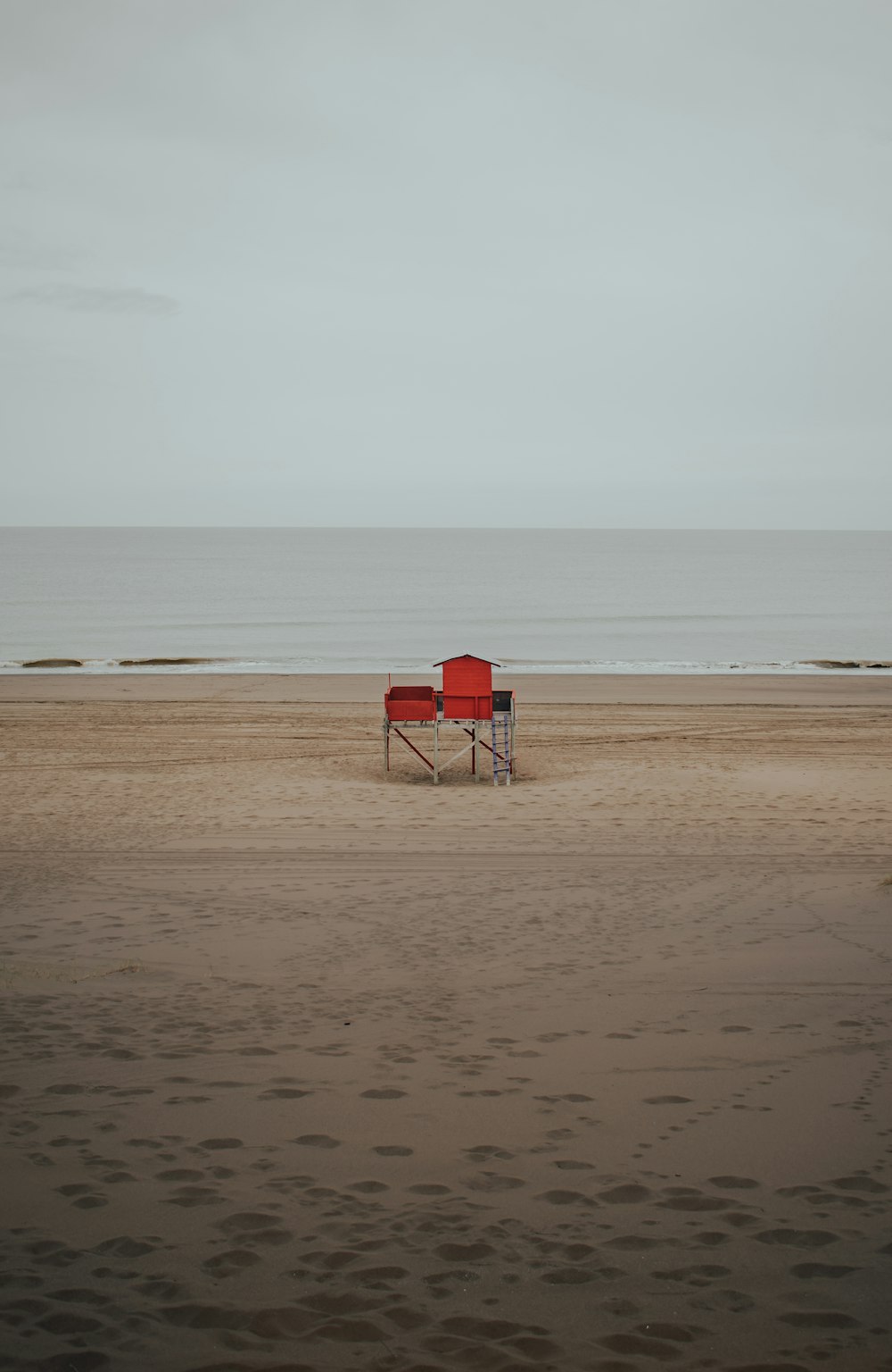 red and white chair on beach during daytime