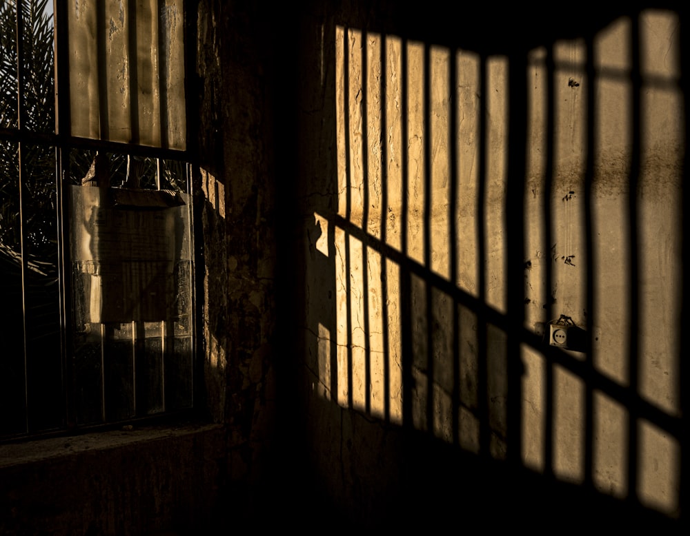 grayscale photo of window with metal grille