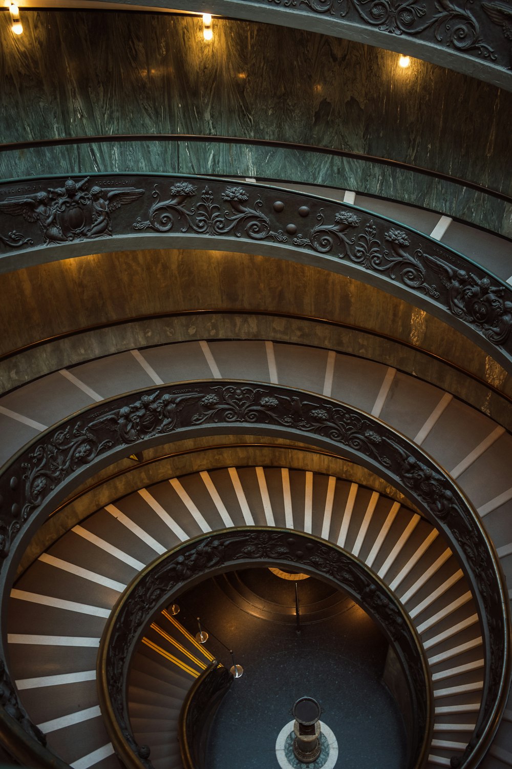 a spiral staircase in a building with a clock on it