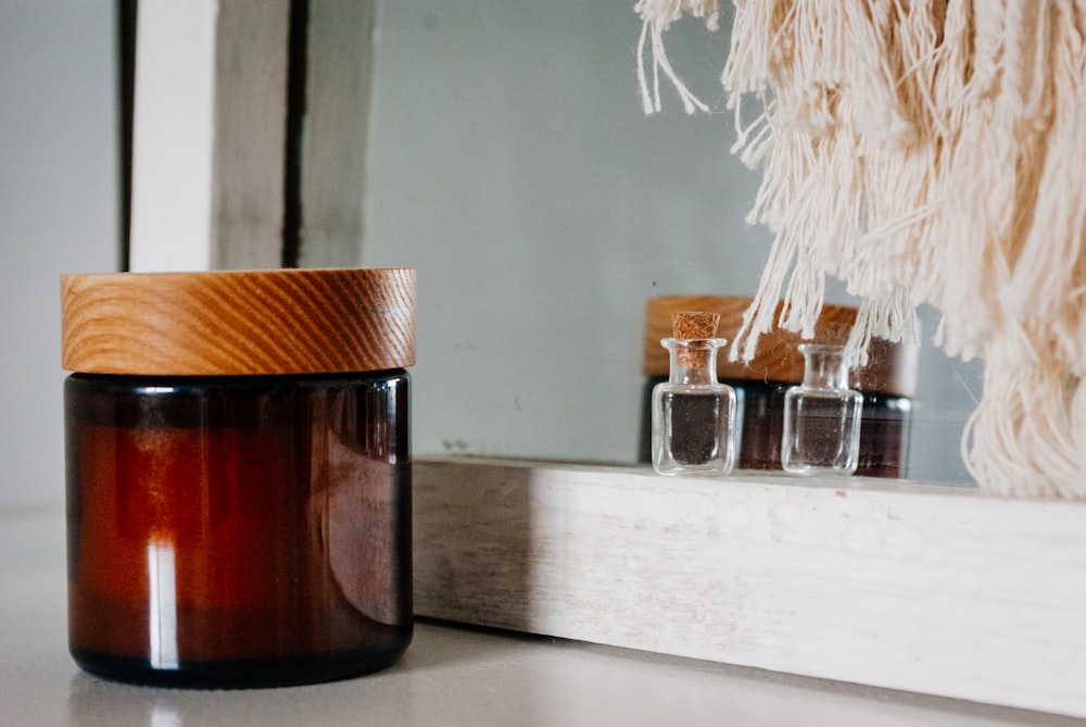 brown glass jar on white wooden table