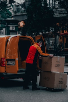 Courier unloading a parcel from a van