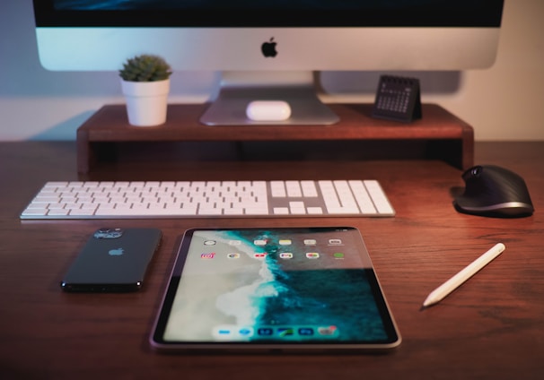 silver imac on brown wooden table